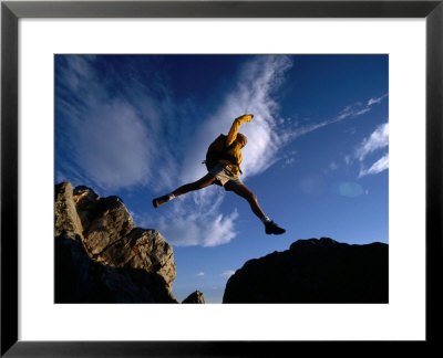 Hiker Jumping Between Rocks In The Wasatch Mountains, Wasatch-Cache National Forest, Utah, Usa by Cheyenne Rouse Pricing Limited Edition Print image