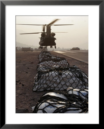 Marine Specialists Attach Sling Loads To The Body Of An Army Ch-47 Chinook Cargo Helicopter by Stocktrek Images Pricing Limited Edition Print image
