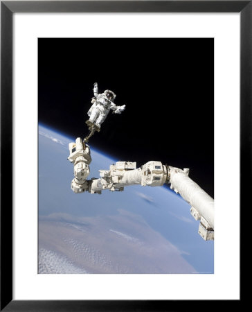 Astronaut Anchored To A Foot Restraint by Stocktrek Images Pricing Limited Edition Print image
