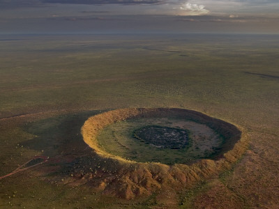An Aerial View Of A Meteor Impact Crater Near The Town Of Halls Creek by Randy Olson Pricing Limited Edition Print image