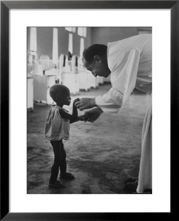 Roman Catholic Priest Chatting With Healing Child by Terence Spencer Pricing Limited Edition Print image
