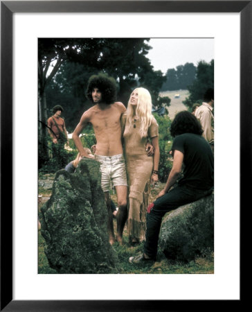 Hippie Couple Posed Together Arm In Arm With Others Around Them, During Woodstock Music/Art Fair by John Dominis Pricing Limited Edition Print image