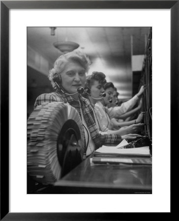 Line Of Operators At Macy's Main Switchboard, With Alice Lennon Flipping Through A Rolodex File by Nina Leen Pricing Limited Edition Print image