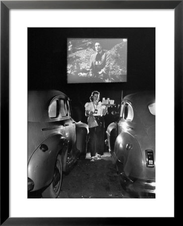 Carhop Carries Tray Of Food And Drinks To Car Occupants At Drive-In Movie by Allan Grant Pricing Limited Edition Print image