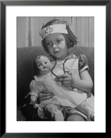 Evelyn Mott Playing Nurse With Doll As Parents Adjust Children To Abnormal Conditions In Wartime by Alfred Eisenstaedt Pricing Limited Edition Print image
