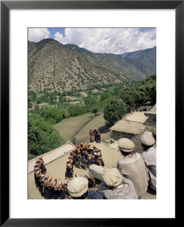 Men Watching Kalash Women Dancing, Spring Festival, Joshi, Bumburet Valley, Pakistan, Asia by Upperhall Ltd Pricing Limited Edition Print image