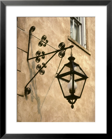 Iron Street Lamp Hangs From A Historic Building by Rex Stucky Pricing Limited Edition Print image