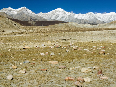 Snowy Peaks Rise Above A Dry Plain In Mustang, Nepal by Stephen Sharnoff Pricing Limited Edition Print image