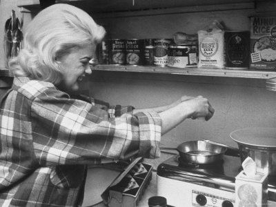 Jane Mansfield Cracking An Egg Over A Frying Pan On Electric Hot Plate In Her Home by Peter Stackpole Pricing Limited Edition Print image