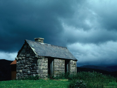 Storm Clouds Pass Over A Bluestone Cottage In The Scottish Highlands by Jerry Galea Pricing Limited Edition Print image