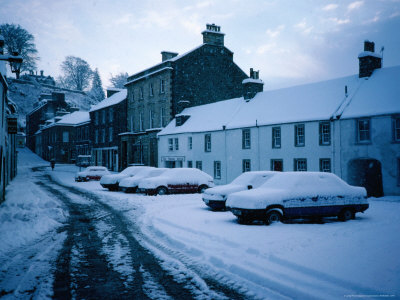 Cars Under Snow In The High Street Of Dunkeld - Perth And Kinross, Scotland by Cornwallis Graeme Pricing Limited Edition Print image