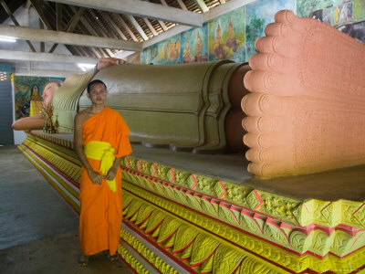 Yyoung Monk In Front Of Reclining Buddha, Wat Rathana Ransi by Noboru Komine Pricing Limited Edition Print image