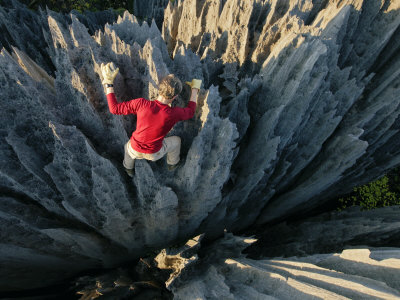 Climber On Limestone Pinnacles In The Grand Tsingy Of Bekopaka by Stephen Alvarez Pricing Limited Edition Print image