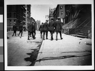 Rear View Of A Group Of Men In Uniform, Wearing Riding Boots And Walking Down A City Street by Wallace G. Levison Pricing Limited Edition Print image