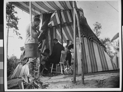 A Man Having His Fortune Told Through A Palm Reading By An Amateur Gypsy Woman In A Tent by George B. Brainerd Pricing Limited Edition Print image