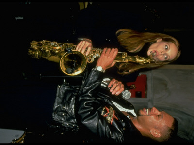 Cafe Co-Owner Elle Macpherson Playing Saxophone, Presented By Jazz Musician Joshua Redman by Dave Allocca Pricing Limited Edition Print image