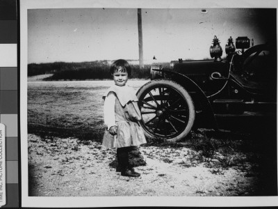 A Young Girl Standing Next To An Automobile by Wallace G. Levison Pricing Limited Edition Print image