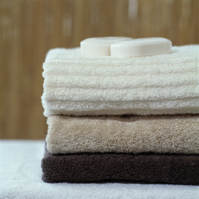 A Stack Of Bath Towels And Two Soap Bars On Top by Jon Pall Vilhelmsson Pricing Limited Edition Print image