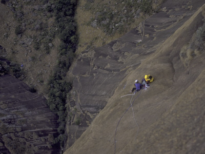 Looking Down At Climbers From Large Rock Wall, Madagascar by Michael Brown Pricing Limited Edition Print image