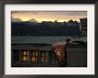 A Worker Cuts A Piece Off A Roof That Was Torn Away During A Storm In Prague, January 19, 2007 by Petr David Josek Limited Edition Print