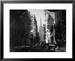 People And Horse Drawn Carriages On Wall St, Where American Flags Are Flying From Several Buildings by George B. Brainerd Limited Edition Print