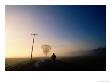A Lone Jogger Runs Down A Rural Road In Early Morning Fog by Melissa Farlow Limited Edition Pricing Art Print