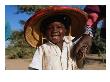 Young Smiling Boy Wearing A Typical Mali Hat And Holding His Mother's Hand, Djenne, Mopti, Mali by Jane Sweeney Limited Edition Print
