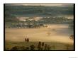 Aerial View Of A Farm And Surrounding Landscape Covered In Fog by Kenneth Garrett Limited Edition Print