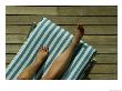 Woman's Legs On A Striped Cushion On The Deck Of A Cruise Ship by Todd Gipstein Limited Edition Print