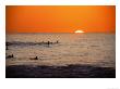 Surfers In Water At Sunset, Hawaii by Vince Cavataio Limited Edition Print