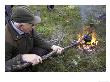 Man (Aged 60 Years) Boiling Kettle Over Open Fire In Forest, Norway by Mark Hamblin Limited Edition Print