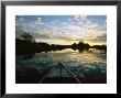 Clouds Reflecting On Waters' Surface At Twilight With Bow Of Boat by Steve Winter Limited Edition Print