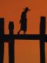Silhouette, Man With Hat On Bridge, Sunset, Myanmar by Inga Spence Limited Edition Print