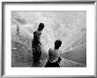 Children Playing In The Spray Of An Open Fire Hydrant To Escape The Ongoing Heat Wave by Peter Stackpole Limited Edition Print