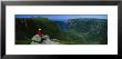 Person Sitting On Cliff, Ten Mile Pond, Gros Morne National Park, Newfoundland And Labrador, Canada by Panoramic Images Limited Edition Pricing Art Print