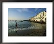 A Beach Goer Wades Into The Calm Surf Of Cadaques by Pablo Corral Vega Limited Edition Print