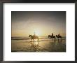 Horseback Riders Silhouetted On A Beach At Twilight, Costa Rica by Michael Melford Limited Edition Print