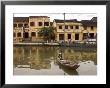 Boat On River In Front Of Yellow Coloured Colonial Buildings, Hoi An, Vietnam, Southeast Asia by Christian Kober Limited Edition Print