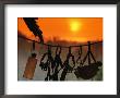 Caving Equipment And Bottle Hang On Line Against A Fiery Sun And Sky by Mark Cosslett Limited Edition Print