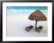 A Palm Frond Umbrella And Two Chairs On A White Sand Beach by Raul Touzon Limited Edition Print