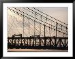 Silhouette Of A Suspension Bridge And Pedestrians by Kenneth Garrett Limited Edition Print