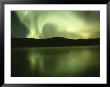 Green And White Streamers Of Aurorae Light Up The Arctic Sky by Paul Nicklen Limited Edition Print