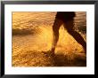 Close View Of A Runners Legs Splashing Through The Surf by Phil Schermeister Limited Edition Print