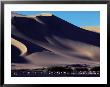Sand Dunes Soar Above An Oasis In Namibia by Annie Griffiths Belt Limited Edition Pricing Art Print