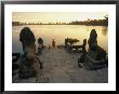 Two Buddhist Monks Sit At The Waters Edge At A Lake Temple In The Angkor Wat Complex by Paul Chesley Limited Edition Print