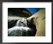 Suspended In Mid-Air, A Kayaker Sails Down Short Waterfall And Is Headed For The White Water Below by Barry Tessman Limited Edition Print