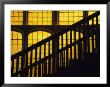 A Staircase In Silhouette Against A Yellow Stained Glass Window by David Evans Limited Edition Print