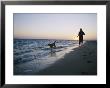 Woman And Dog Running On Beach, Nags Head, North Carolina by Skip Brown Limited Edition Pricing Art Print