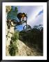 Man Jumping On His Mountain Bike With Ha Ling Peak In The Background by Mark Cosslett Limited Edition Pricing Art Print