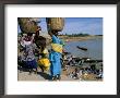 Women With Baskets Of Laundry On Their Heads Beside The River, Djenne, Mali, Africa by Bruno Morandi Limited Edition Print